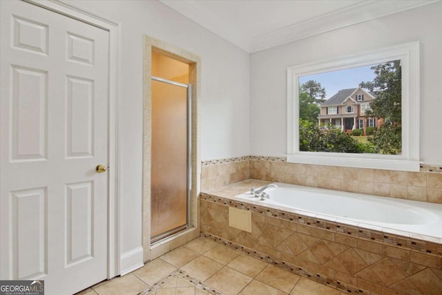 bathroom featuring a shower stall, tile patterned floors, crown molding, and a bath