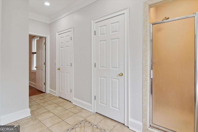 interior space featuring crown molding, baseboards, light tile patterned flooring, and recessed lighting