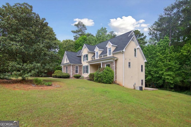 exterior space featuring stucco siding and a lawn