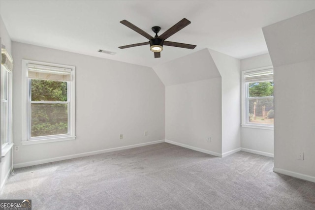 bonus room with carpet floors, visible vents, baseboards, ceiling fan, and vaulted ceiling