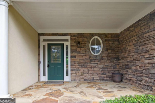 property entrance featuring stone siding and stucco siding