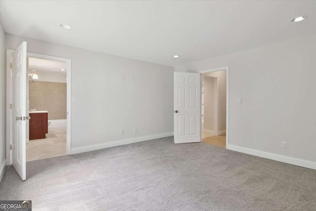 unfurnished bedroom featuring baseboards, recessed lighting, and carpet