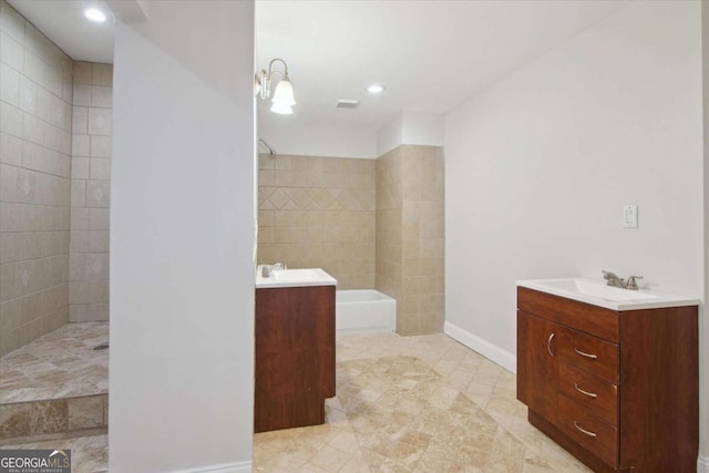 bathroom with baseboards, visible vents, a tile shower, tile patterned floors, and vanity