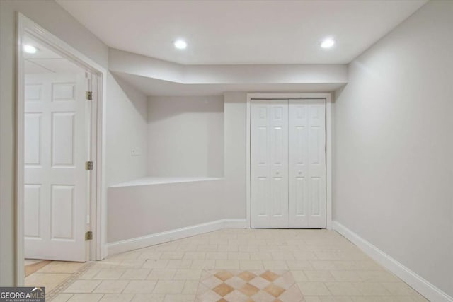 finished basement with baseboards, light tile patterned floors, and recessed lighting