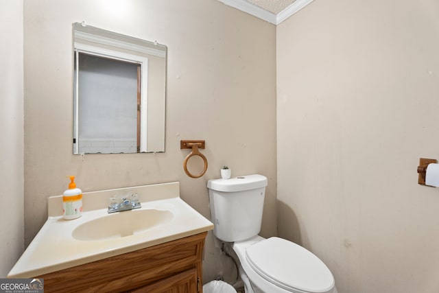 bathroom featuring vanity, crown molding, and toilet