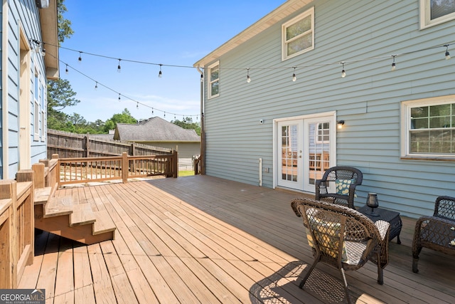 deck with french doors and fence