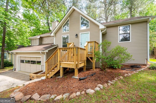 view of front facade featuring a chimney, an attached garage, concrete driveway, a deck, and stairway