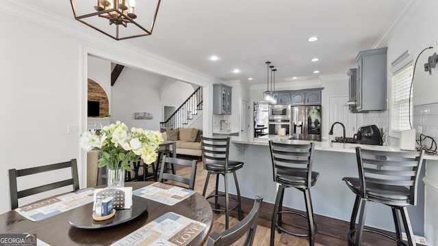 11440 Azalea Trl, Hampton, GA 30228 - dining space featuring recessed lighting, crown molding, a notable chandelier, and stairs