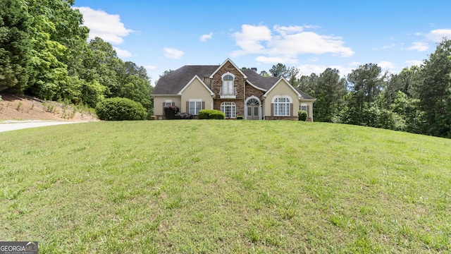 11440 Azalea Trl, Hampton, GA 30228 - view of front of home featuring a front lawn, stucco siding, and a chimney