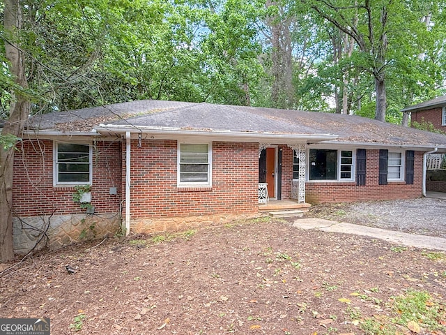 668 Lynn Cir SW, Atlanta, GA 30311 - ranch-style home with a shingled roof, brick siding, and covered porch