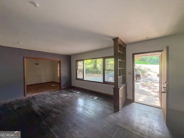 668 Lynn Cir SW, Atlanta, GA 30311 - unfurnished living room featuring baseboards and wood finished floors