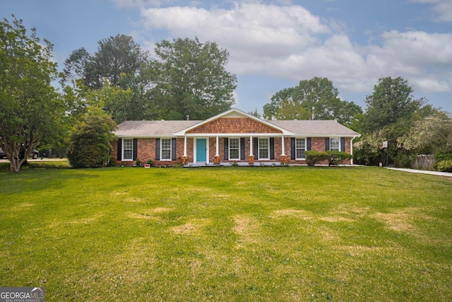599 Honey Creek Rd, Conyers, GA 30094 - ranch-style house with a front yard, brick siding, and covered porch