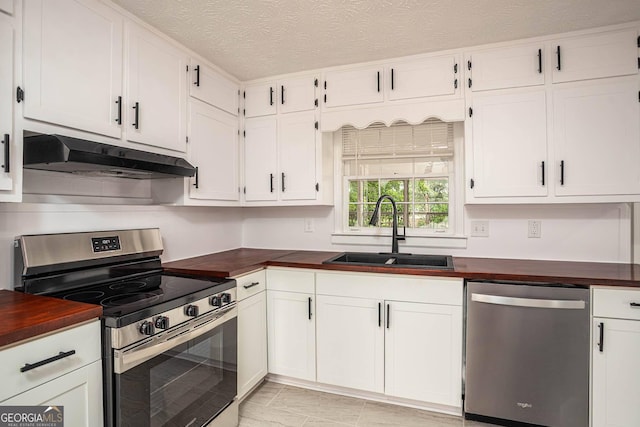 599 Honey Creek Rd, Conyers, GA 30094 - kitchen with stainless steel appliances, under cabinet range hood, a sink, wood counters, and a textured ceiling