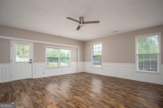 599 Honey Creek Rd, Conyers, GA 30094 - entryway featuring a textured ceiling, wood finished floors, a ceiling fan, a wainscoted wall, and a decorative wall