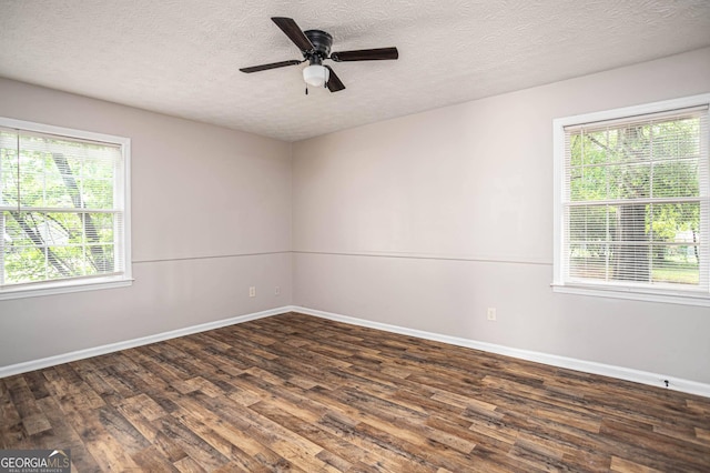 599 Honey Creek Rd, Conyers, GA 30094 - empty room with plenty of natural light, wood finished floors, baseboards, and a textured ceiling