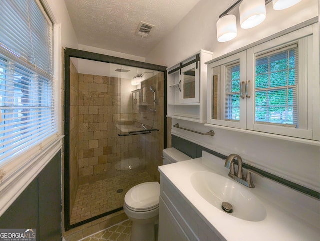 599 Honey Creek Rd, Conyers, GA 30094 - bathroom featuring a stall shower, healthy amount of natural light, vanity, and a textured ceiling