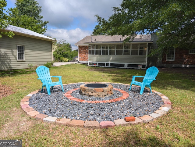 599 Honey Creek Rd, Conyers, GA 30094 - view of grassy yard featuring a fire pit and a sunroom