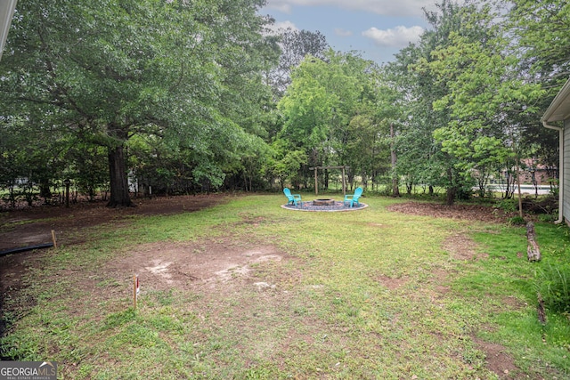 599 Honey Creek Rd, Conyers, GA 30094 - view of grassy yard featuring a fire pit
