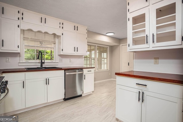 599 Honey Creek Rd, Conyers, GA 30094 - kitchen with stainless steel dishwasher, a sink, baseboards, glass insert cabinets, and white cabinets