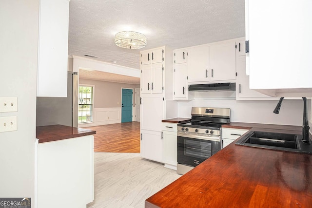 599 Honey Creek Rd, Conyers, GA 30094 - kitchen featuring stainless steel electric range, a sink, under cabinet range hood, butcher block countertops, and a textured ceiling