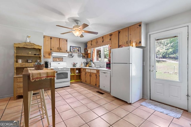 kitchen featuring white appliances, under cabinet range hood, plenty of natural light, and a ceiling fan