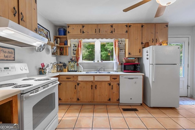 kitchen with white appliances, a sink, under cabinet range hood, light countertops, and a ceiling fan