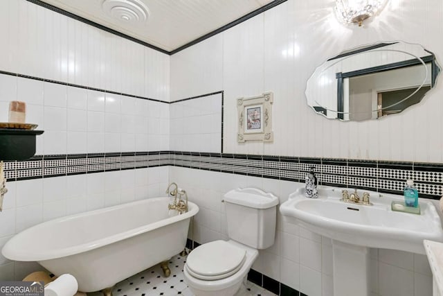 bathroom with a soaking tub, tile walls, and toilet