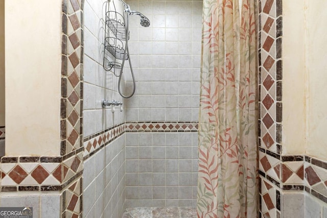 bathroom with tiled shower