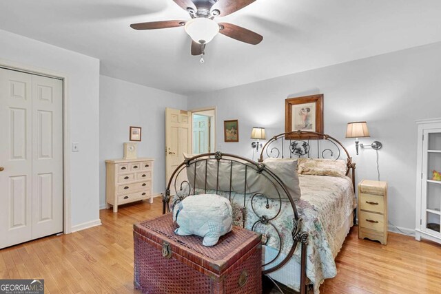 bedroom featuring wood finished floors, a ceiling fan, and baseboards