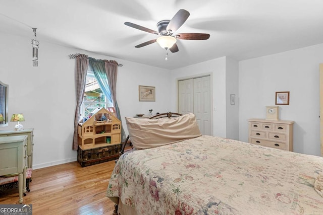 16335 Henderson Rd, Milton, GA 30004 - bedroom featuring light wood-type flooring, a closet, a ceiling fan, and baseboards