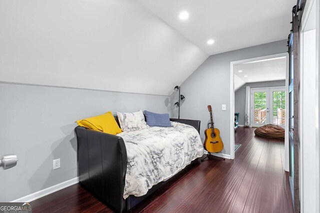 bedroom featuring vaulted ceiling, baseboards, dark wood finished floors, recessed lighting, and a barn door