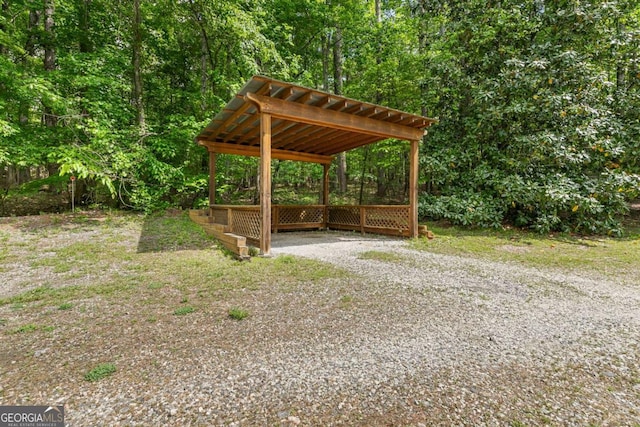 view of property's community with driveway and a forest view