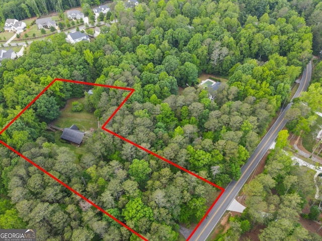 16335 Henderson Rd, Milton, GA 30004 - aerial view of property and surrounding area featuring property parcel outlined and a heavily wooded area