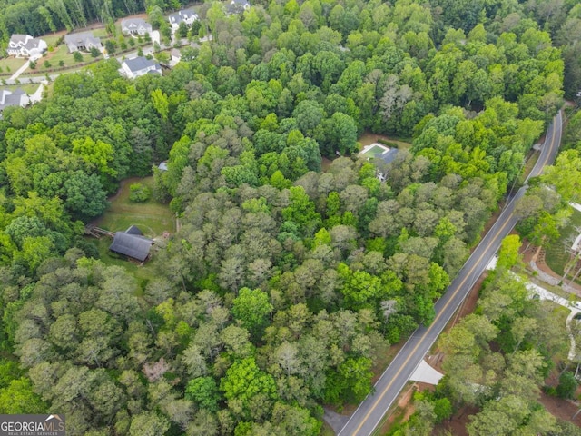 aerial view of property's location featuring a heavily wooded area