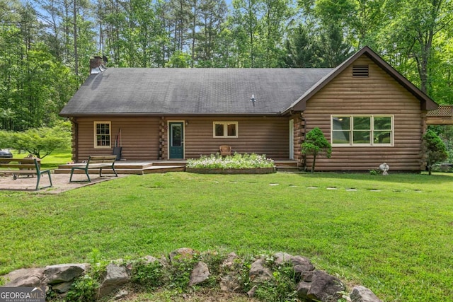 16335 Henderson Rd, Milton, GA 30004 - view of front of property with log siding, a front yard, and a chimney