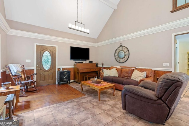 16335 Henderson Rd, Milton, GA 30004 - living room with light tile patterned floors, a wainscoted wall, high vaulted ceiling, and ornamental molding