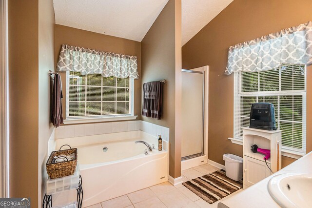 1071 Wildflower Way, Madison, GA 30650 - full bath featuring a bath, tile patterned flooring, a stall shower, lofted ceiling, and baseboards
