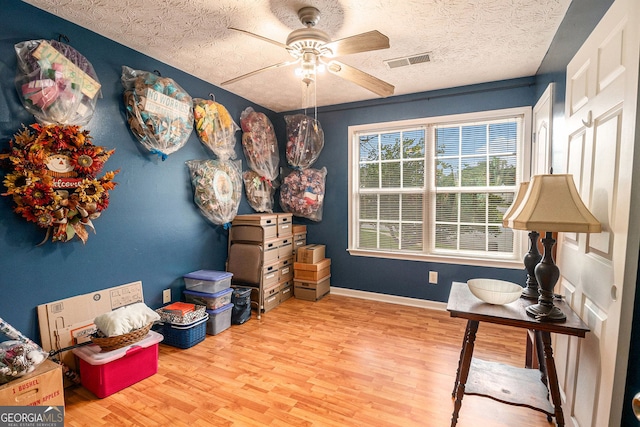 1071 Wildflower Way, Madison, GA 30650 - office area featuring wood finished floors, a ceiling fan, baseboards, and a textured ceiling