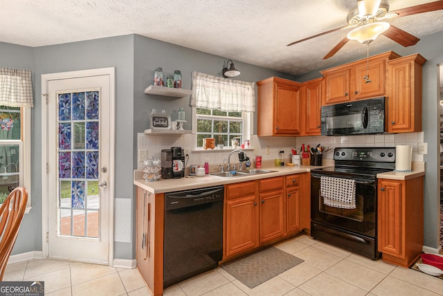 1071 Wildflower Way, Madison, GA 30650 - kitchen with black appliances, a sink, light countertops, tasteful backsplash, and a textured ceiling