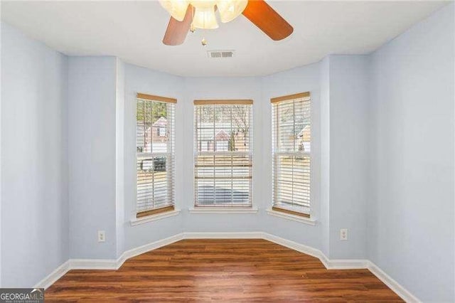 334 Hunterian Pl, Newnan, GA 30265 - empty room featuring wood finished floors, visible vents, baseboards, and ceiling fan