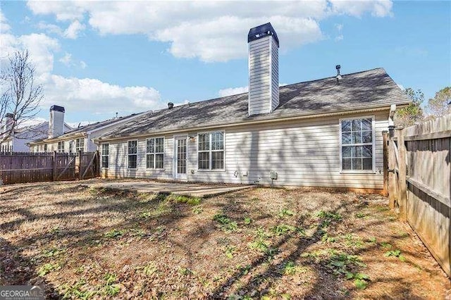 334 Hunterian Pl, Newnan, GA 30265 - back of property featuring a patio area, a chimney, and a fenced backyard