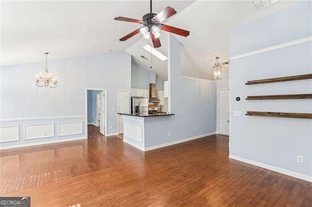 334 Hunterian Pl, Newnan, GA 30265 - unfurnished living room with ceiling fan with notable chandelier, high vaulted ceiling, baseboards, and wood finished floors