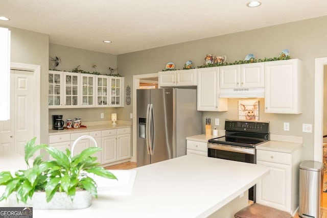 17 Hampton Way, Carrollton, GA 30116 - kitchen with under cabinet range hood, stainless steel appliances, recessed lighting, and white cabinets