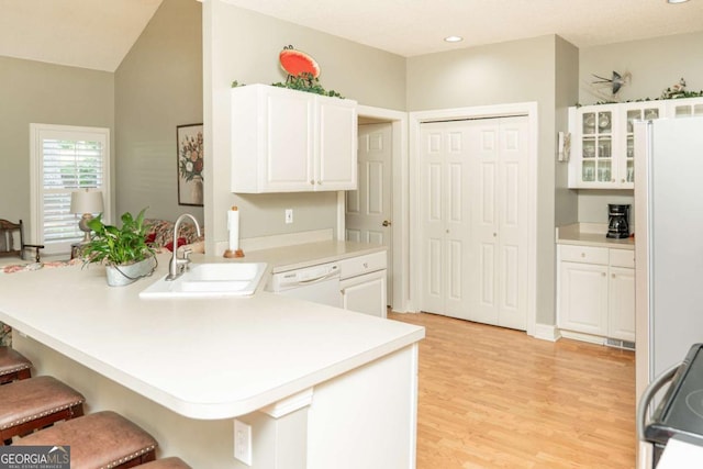 17 Hampton Way, Carrollton, GA 30116 - kitchen with white appliances, a sink, a peninsula, a kitchen breakfast bar, and white cabinets