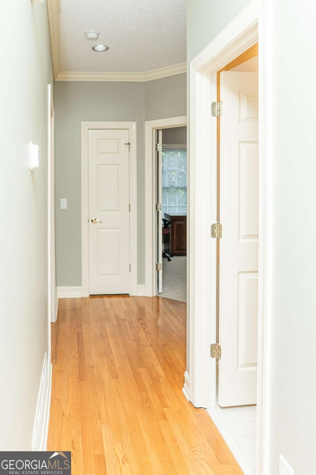17 Hampton Way, Carrollton, GA 30116 - hall featuring light wood-style floors, crown molding, and a textured ceiling