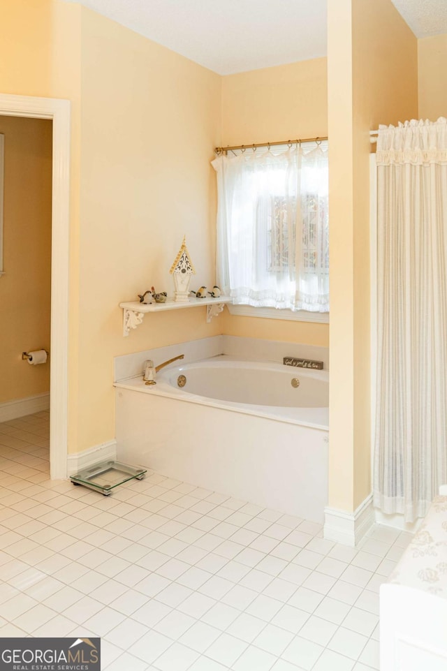 17 Hampton Way, Carrollton, GA 30116 - bathroom featuring tile patterned floors, baseboards, and a garden tub