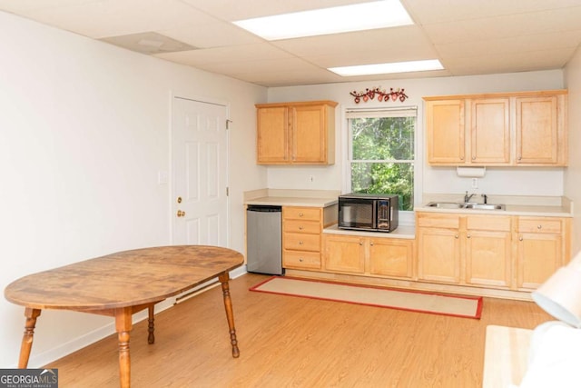 17 Hampton Way, Carrollton, GA 30116 - kitchen with light brown cabinetry, black microwave, light wood-style floors, light countertops, and a paneled ceiling