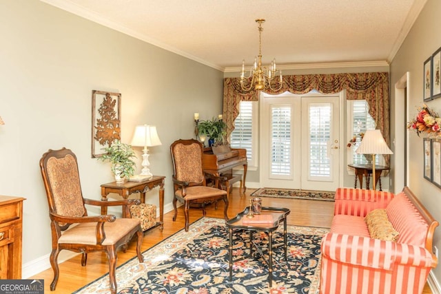 17 Hampton Way, Carrollton, GA 30116 - living area with a chandelier, wood finished floors, baseboards, and ornamental molding