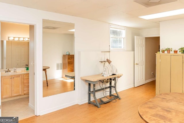 17 Hampton Way, Carrollton, GA 30116 - interior space featuring a sink, light wood finished floors, baseboards, and visible vents