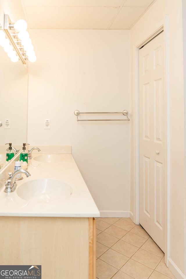 17 Hampton Way, Carrollton, GA 30116 - bathroom featuring double vanity, tile patterned flooring, baseboards, and a sink